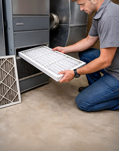 Technician replacing HVAC air filter to help prevent mold growth